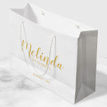 Modern Script Gold Personalised Bridesmaids Large Gift Bag<br><div class="desc">Modern Script Gold Personalised Bridesmaids Gift Bag featuring personalised bridesmaid's name in gold modern calligraphy font style with title and wedding date in modern sans serif font style on white background. Also perfect for Maid of Honour, Flower Girl, Mother of the Bride, Groomsmen, Best man and more. Please Note: The...</div>