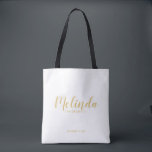 Modern Script Gold Personalised Bridesmaids Tote Bag<br><div class="desc">Modern Script Gold Personalised Bridesmaids Tote Bag featuring personalised bridesmaid's name in gold modern calligraphy font style with title and wedding date in modern sans serif font style on white background. Also perfect for Maid of Honour, Flower Girl, Mother of the Bride and more. Please Note: The foil details are...</div>
