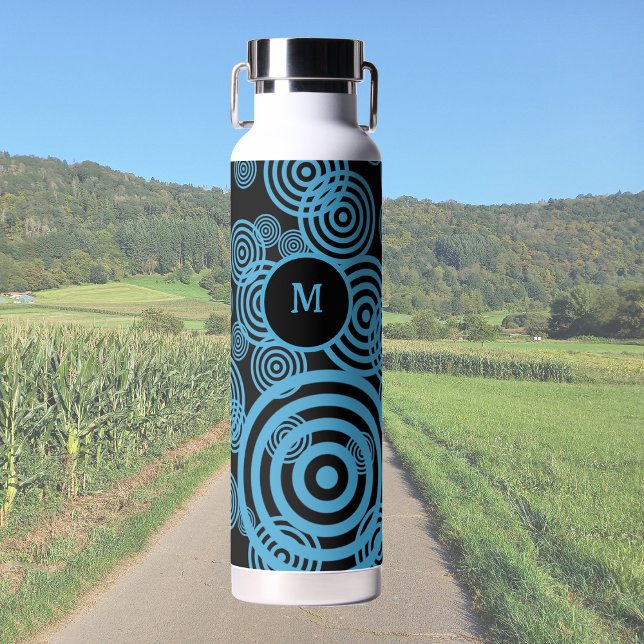 Modern, trendy blue circles on black monogram  water bottle (Creator Uploaded)