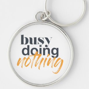 Modern, trendy, urban design of Busy Doing Nothing Key Ring