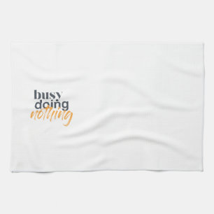 Modern, trendy, urban design of Busy Doing Nothing Tea Towel