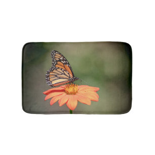 Monarch Butterfly on an orange flower Bath Mat