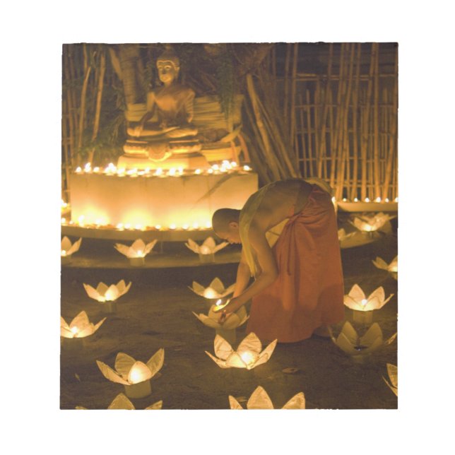 Monks lighting khom loy candles and lanterns for notepad (Front)
