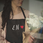Monogram Black Red Heart Handwritten Script Apron<br><div class="desc">A minimalist monogram design with large typography initials in a script font with a red heart on a simple black background. The perfectly custom gift or accessory!</div>