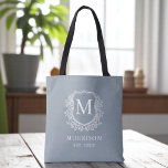 Monogram Dusty Blue Crest Botanical Wedding  Tote Bag<br><div class="desc">Bring soft elegance to your celebration with our Monogram Dusty Blue Crest Botanical Wedding Tote Bag. Featuring a serene dusty blue background, a refined botanical crest, and your personalised monogram, this tote blends timeless charm with modern style. Perfect for wedding welcome bags, bridal party gifts, or guest favours, it offers...</div>