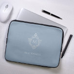 Monogram Dusty Blue Elegant Crest Faux Silver Name Laptop Sleeve<br><div class="desc">An elegant dusty blue and silver design with the monogram initial in a vintage crest, recommended for a man. The crest is faux silver foil, the background is dusty blue. Under the crest there is the name in grey caps. The vintage floral crest from an old book cover binding, of...</div>