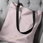 Monogram Elegant Minimal Blush Pink and Gold Tote Bag<br><div class="desc">A simple stylish custom monogram design in a gold modern minimalist typography on an elegant pastel blush pink background. The monogram initials and name can easily be personalized along with the feature line to make a design as unique as you are! The perfect bespoke gift or accessory for any occasion....</div>