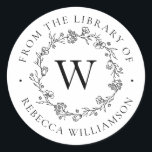 Monogram Floral Wreath From the Library Bookplate Classic Round Sticker<br><div class="desc">Add an elegant touch to all your favourite books with our chic Floral Wreath Monogram From the Library of Bookplate, featuring your single initial monogram in classic serif lettering, framed by a hand-drawn wreath of flowers, buds and tiny botanical leaves. "From the library of" appears in a gorgeous circular arc...</div>