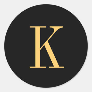 Monogram K gold-coloured on black background Classic Round Sticker