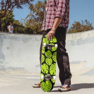 Monstera leaves in Lime Green and black Skateboard