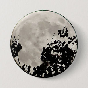 Moon behind dark leaves 7.5 cm round badge