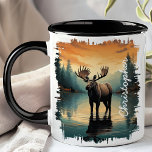 Moose at Sunrise Lake Reflection Mug<br><div class="desc">Begin your day with the majestic beauty of the Moose at Sunrise Lake Reflection Mug. This captivating mug features a stunning image of a moose standing in a serene lake at sunrise, with the warm colours of dawn and the tranquil forest beautifully reflected in the water. Customised with your name,...</div>