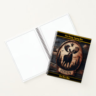 Moose carving on dark wood in nature notebook