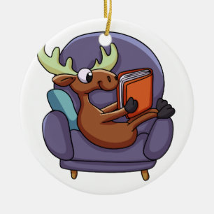 Moose reading a book on a sofa   choose back colou ceramic tree decoration
