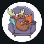 Moose reading a book on a sofa | choose back colou classic round sticker<br><div class="desc">moose  deer  reindeer illustration ,  cartoon  animal  head  funny  , mascot  elk  nature  wild  , drawing  wildlife  horn  design ,  forest   happy  antler  comic ,  smile  cheerful  christmas  animals,   cute book  books  library ,  education  story  reading  school  , study  bookstore  studying  student , reindeer moose  deer</div>