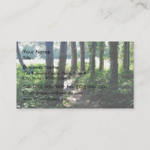 Morning light illuminates a woodland path business card