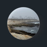 Morro Bay California Coastal Photography 6 Cm Round Badge<br><div class="desc">A foggy overcast day in Morro Bay California with the ocean waves hitting the rocks on the shore in this beach photograph souvenir. This seaside travel photo keepsake button features black cursive script above the beach rocks and grey sky.</div>