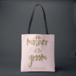 Mother of the Groom Gold Glitter Blush PInk Tote Bag<br><div class="desc">This Mother of the Groom tote bag is perfect for proud moms to tote around all their belongings at the bridal shower or the main event. This blush pink tote bag features faux gold glitter style lettering on the front. Personalise these totes with your wedding party member's name on the...</div>