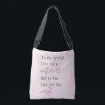 Mother Quote Pink Crossbody Bag<br><div class="desc">Celebrate Mom with this elegant tote bag featuring the heartfelt quote “To the World You Are a Mother, But to Me You Are the World.” Designed with soft blush pink tones and modern typography, this stylish bag blends sentiment with everyday practicality. Perfect for shopping, daily errands, or thoughtful Mother’s Day...</div>