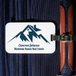 Mountain Real Estate Company Personalised Realtor Luggage Tag<br><div class="desc">A cool mountain range real estate company luggage tag for a realty business located in a mountainous city or town. The realtor name is written in navy blue script under the house among mountains. Great marketing item for a mountaintop home builder.</div>