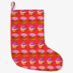 Muffins, cupcakes with white and pink cream on a r small christmas stocking