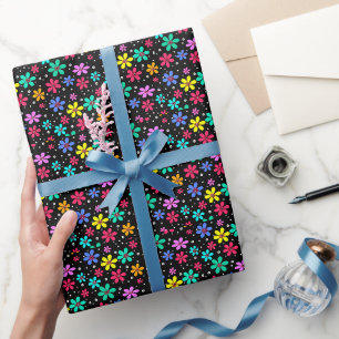 Multi-coloured daisies on a black background wrapping paper