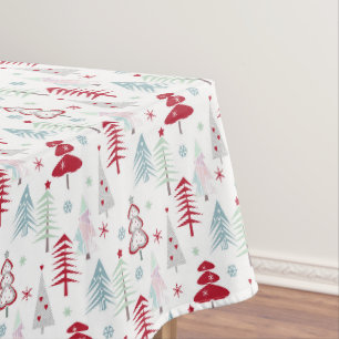 Multicolored Christmas trees on a white Tablecloth