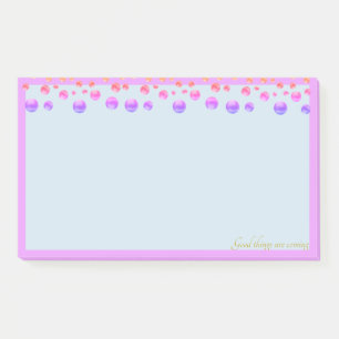 Multicolored confetti on light blue post-it notes