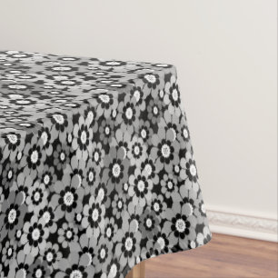 Multicolored paper cut flowers on black background tablecloth