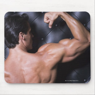 Muscular man flexing mouse pad