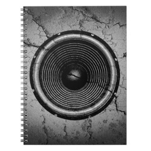 Music speaker on a cracked wall spiral notebook