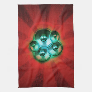 Music speakers and red sunburst tea towel