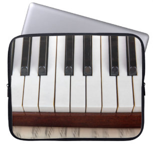 musical notes on the background of a pianoacoustic laptop sleeve