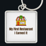My First Restaurant Keychain – I Earned It – Proud<br><div class="desc">Celebrate the pride of opening your very first restaurant! This keychain features the bold phrase "My First Restaurant – I Earned It", perfect for anyone who worked hard to achieve this milestone. Whether it’s a diner, café, or full-service restaurant, this keychain is a fun and meaningful reminder of dedication and...</div>