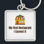 My First Restaurant Keychain – I Earned It – Proud<br><div class="desc">Celebrate the pride of opening your very first restaurant! This keychain features the bold phrase "My First Restaurant – I Earned It", perfect for anyone who worked hard to achieve this milestone. Whether it’s a diner, café, or full-service restaurant, this keychain is a fun and meaningful reminder of dedication and...</div>