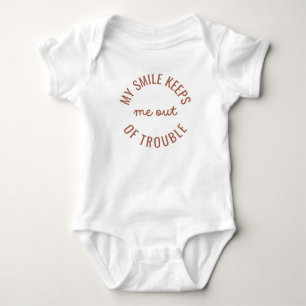 My smile keeps me out of trouble baby bodysuit