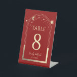Mystical Red Gold Sun Moon Stars Celestial Wedding Pedestal Sign<br><div class="desc">Mystical Dark Red Gold Sun Moon Stars Wedding Table Numbers Pedestal Sign features a gold sun,  moon and stars frame on a dark red background. Inside is your custom table number information. Designed for you by ©2022 Evco Studio www.zazzle.com/store/evcostudio</div>