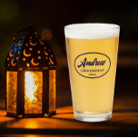 Navy Blue Stylised Wedding Groomsman Name Glass<br><div class="desc">Beer glass for the wedding groomsman that features his name printed in a trendy, navy blue, stylised script inside a navy blue colour oval border along with wedding date. A great party supply idea for a bachelor party! Personalise your beer glass by editing and replacing name and date with your...</div>