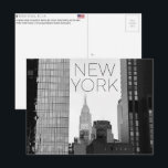 New York, USA Travel Postcard<br><div class="desc">Send this beautiful postcard to your loved ones featuring a vertical urban composition framing the Empire State Building and the New Yorker Hotel through a narrow gap between modern skyscrapers.</div>