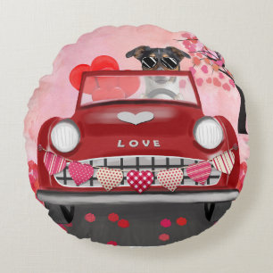 Newfoundland in car with hearts round cushion
