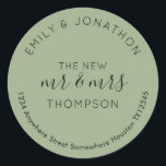 Newlyweds Return Name Address Sage Green Classic Round Sticker<br><div class="desc">A modern fully customisable typographical design with your names curved above and your return address curved below and text in the middle The New Mr and Mrs And your married name in black on a sage green background. All the text can be easily personalised. You can also change background and...</div>