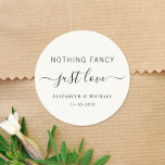 Nothing Fancy Just Love Cream Wedding Classic Round Sticker<br><div class="desc">A chic light cream sticker for your wedding invitations,  favours and thank you cards featuring "Nothing Fancy Just Love" showcased in a blend of simple lettering and an elegant script with swashes,  and your names and wedding or reception date in classic serif typography.</div>