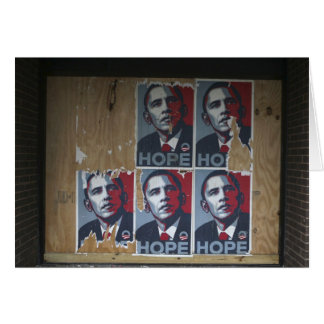 Obama signs in a boarded window of a closed