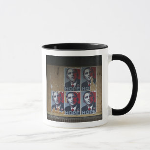 Obama signs in a boarded window of a closed mug