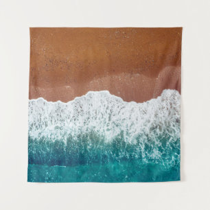 Ocean wave on a sandy beach, background top view tapestry