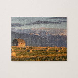 Old barn framed by hay bales and dramatic jigsaw puzzle