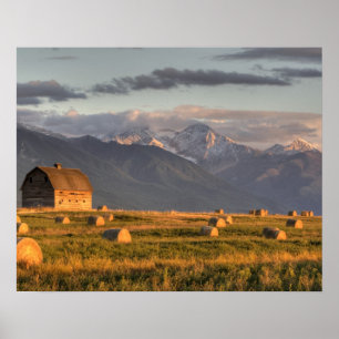 Old barn framed by hay bales and dramatic poster