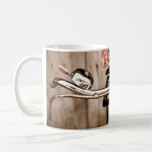 Old bicycle and flowers blur in background process coffee mug