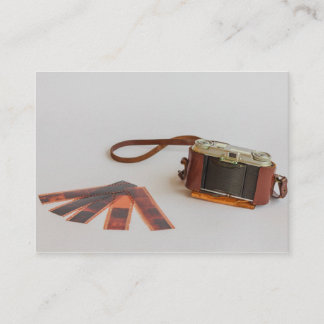 old camera with negative business card