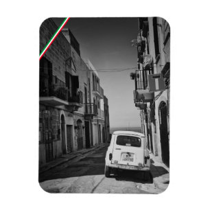 Old car in a street in Italy with sea Magnet